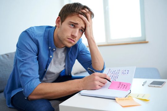 Когнитивные проблемы при шизофрении Парень сидит за столом с записками